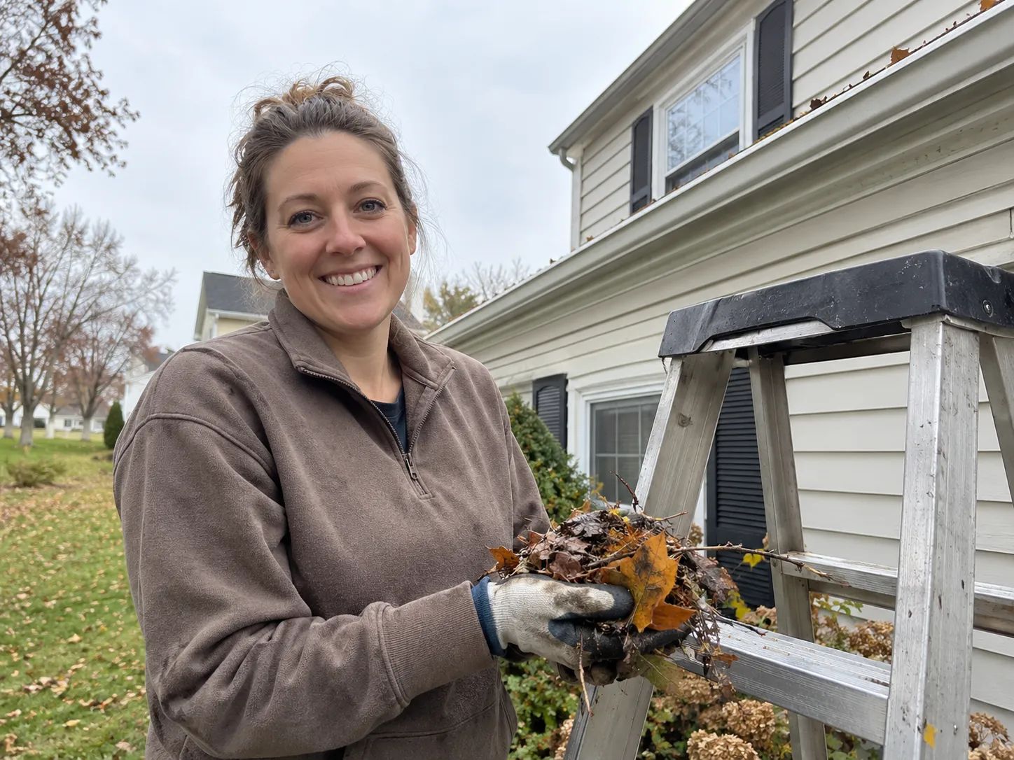 Homeowner checking gutters for shingle granules near Kenner